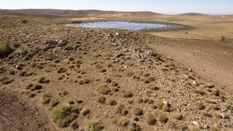 Flight by drone between natural lake and mountains Stock Footage 127376090