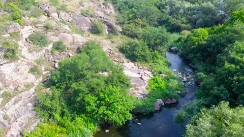 Flight of the drone at medium speed over the river’s water stream through the Stock Footage 134145359