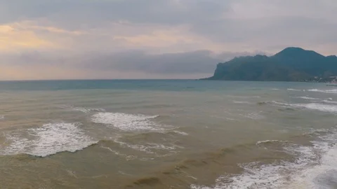 Flight of a drone over the beach of a coastal village Stock Footage 86565305