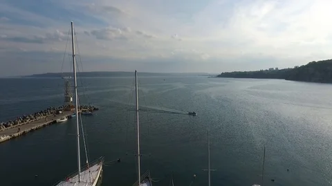 Flight with the drone over the blue sea and yacht port Stock Footage