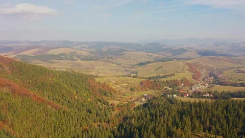 Flight of the drone over the forest and mountains in the early morning at sun Stockbeeldmateriaal 118395933