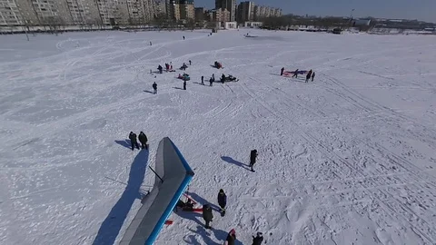Flight on drone over the hang-glider standing in the snow on the lake. Stock Footage 104766362