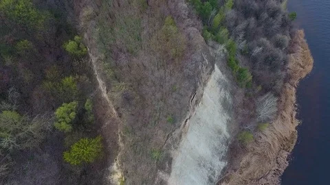 The flight of the drone over the hills covered with forest near the river. Stock Footage 74223782