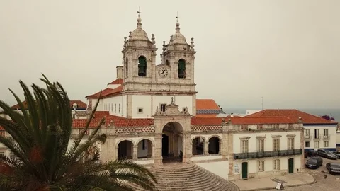 Flight on a drone over Nossa Senhora da Nazare, sanctuary and sandy beach in Stock Footage