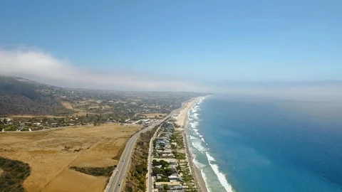 Flight of a drone over the ocean and coast with a road and cars, a settlement Video stock 126676760