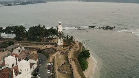 Flight on the drone over the old England fort with a lighthouse at sunset. Sri L Stock Footage 104856248