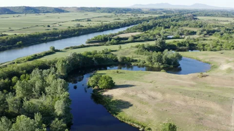 Flight with a drone over river meanders by a big canal Stock Footage 133673262