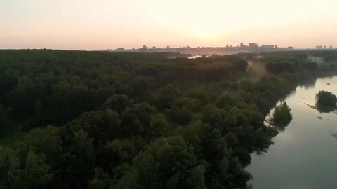 The flight of the drone over the river at sunset . beautiful little island Видео 78543203