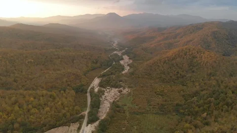 Flight of the drone over the road among the mountains covered with forest Stock Footage 119878695