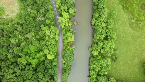 Flight with drone over a road around a river 스톡 동영상 131744453