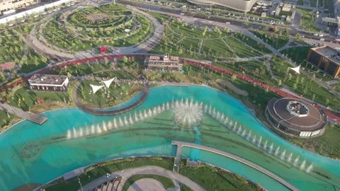 The flight of the drone on a sunny day over the park. A beautiful fountain in Stock Footage 248285904