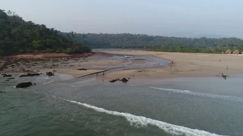 A flight on the drone from the surf line along a small creek. Aerial view. Stock-Footage 85111652