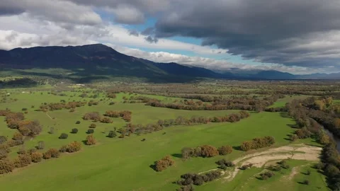 Flight with a drone in a valley on a cloudy afternoon Stock-Footage 245377331
