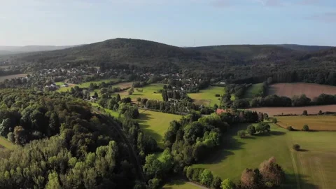 Flight of drones on the edge of the Teutoburg Forest near a village. Stock Footage 138161308