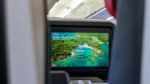 In-flight entertainment screen displaying welcome message in multiple languages Stock Photos