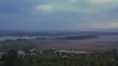 Flight in the evening over the clearing in a covered haze Stock Footage 153041873