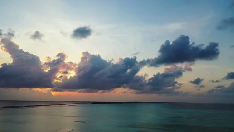 Flight forward. A dramatic purple sky just after sunset above the sea in Video stock 111409368