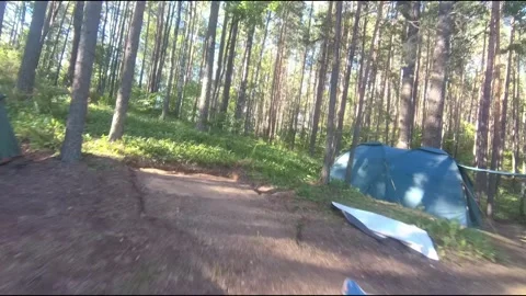 Flight on a fpv drone in the forest through a camp Stock Footage 208629712