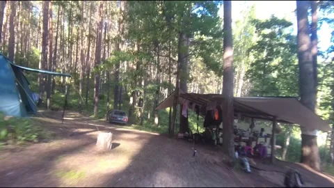 Flight on a fpv drone in the forest through a camp Stock Footage 208629713