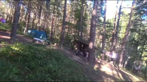 Flight on a fpv drone in the forest through a camp Stock Footage 208629903