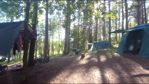 Flight on a fpv drone in the forest through a camp Stock Footage 208629904