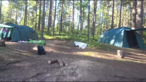 Flight on a fpv drone in the forest through a camp Stock Footage 208630009