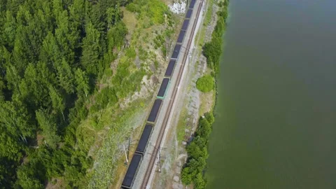 Flight for freight train among the forest on the lake shore, nature of Urals Stock Footage 165343844