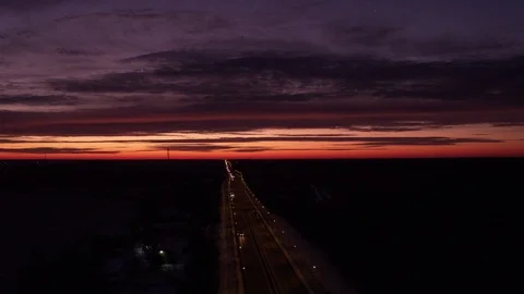 Flight in front of cloudy sunrise above road Stock-Footage 123768841
