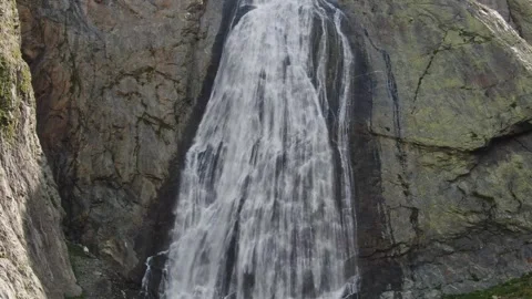 Flight to a high-altitude waterfall. A large wide stream flows down from a flat Stock Footage 269297687