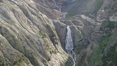 Flight to a high-altitude waterfall. The stream flows from the glacier. Big Stock Footage 269297465