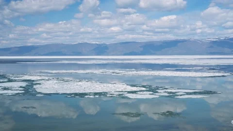 Flight hyperlapse of spring Lake Baikal melting of ice, hummocks, clouds motion  Video stock 202644225