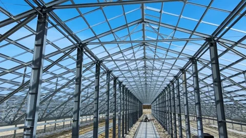 Flight inside the construction of a large metal structure in agricultural area Stock Footage 306300517