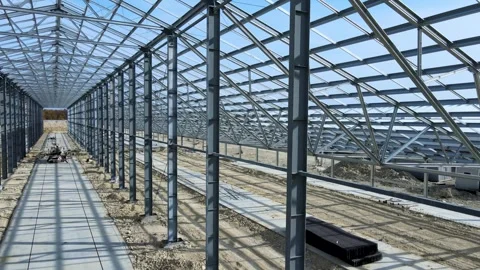 Flight inside the construction of a large metal structure in agricultural area Stock Footage 306300568