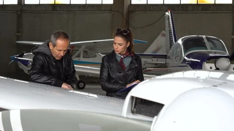 Flight Instructor and Student Pilot Doing the Visual Inspection on an Airplane Stock Footage 106246891
