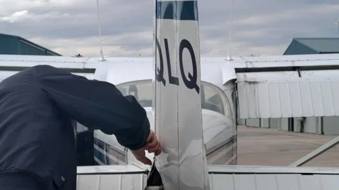 Flight Instructor Checks Rudder of Airplane during External Prelfight Stock Footage 307378890