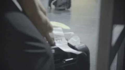 Flight labels being attached to flight cases in slow motion Stock Footage 98765272