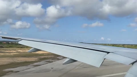 The flight is landed. View from window of plane to wing and land. Stock Footage 163904539