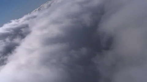 Flight looking back at receding dense clouds, passenger POV Stock Footage 59451381
