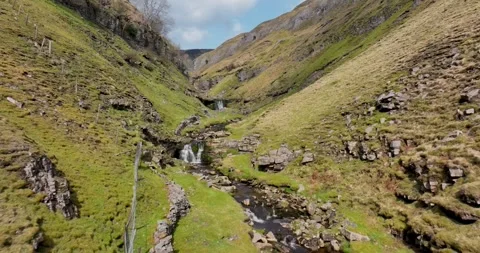 Flight with low angle view up steep sided river valley in Yorkshire Stock-Footage 262083346