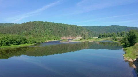 Flight low over the river towards the railway bridge. Stock Footage 116653549