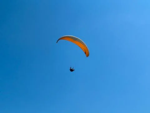 Flight of a man on a paraglider Stock Photos