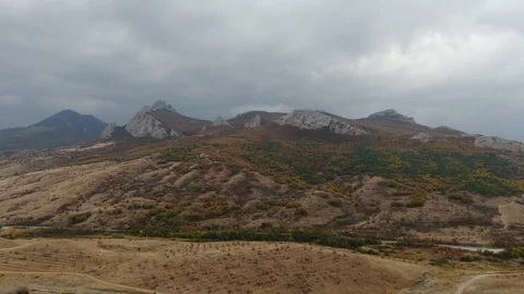 Flight to the mountain range at the foot of which vineyards are located on a Stock Footage 119987951