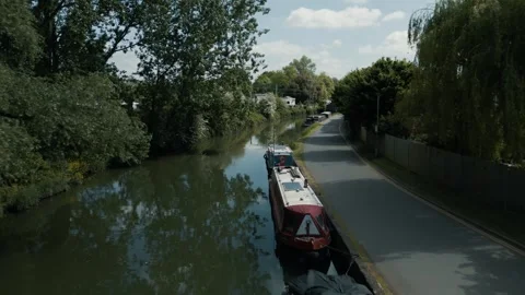 Flight moving forward over over a canal calm waters green banks Stock Footage 296820205