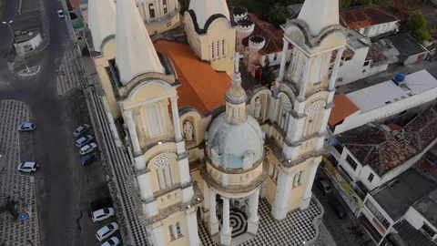 Flight near colonial cathedral while parakeets fly near shot. ilheus, Stock Footage 93845419