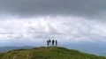 The flight near the dancing people on the mountain top 4k or 4k+ Resolution