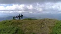 The flight near four friends walking up a mountain 4k or 4k+ Resolution