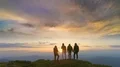The flight near the four people on the mountain against the sunset 4k or 4k+ Resolution