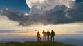 The flight near a four people on the mountain against a sunset 4k or 4k+ Resolution