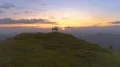 The flight near four people on the mountain top against the sunrise 4k or 4k+ Resolution