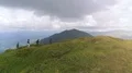The flight near four people walking up a mountain 4k or 4k+ Resolution